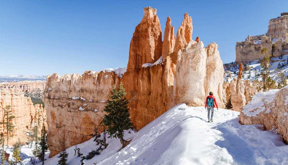 female hiker on a trail in Bryce Canyon National Park during winter