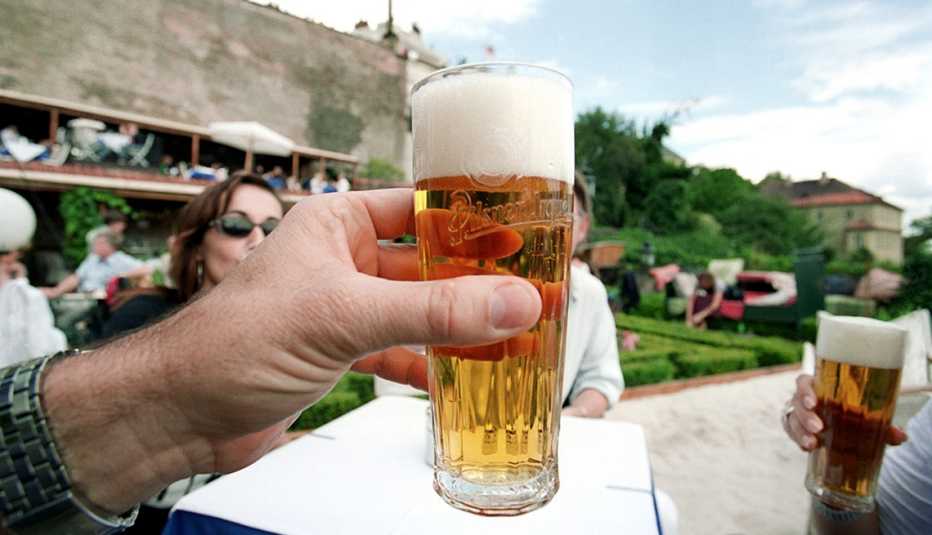 Man Holds Beer Glass And Toasts His Companions At Outdoor Cafe, How To Choose A Guided Tour
