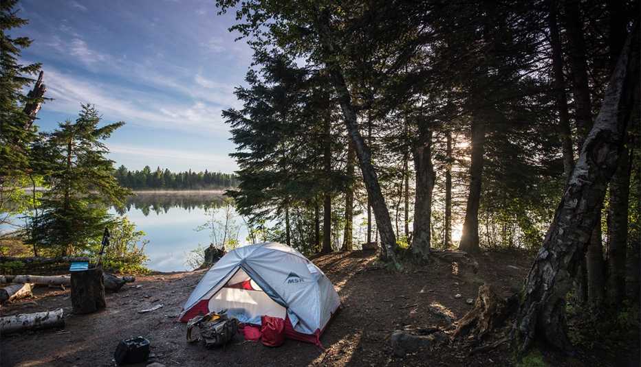 Site 6 at West Chickenbone Lake Campground offers expansive views of Chickenbone Lake for both sunrise and sunset. Here, the morning light makes the lake and the site glow golden with the dawn