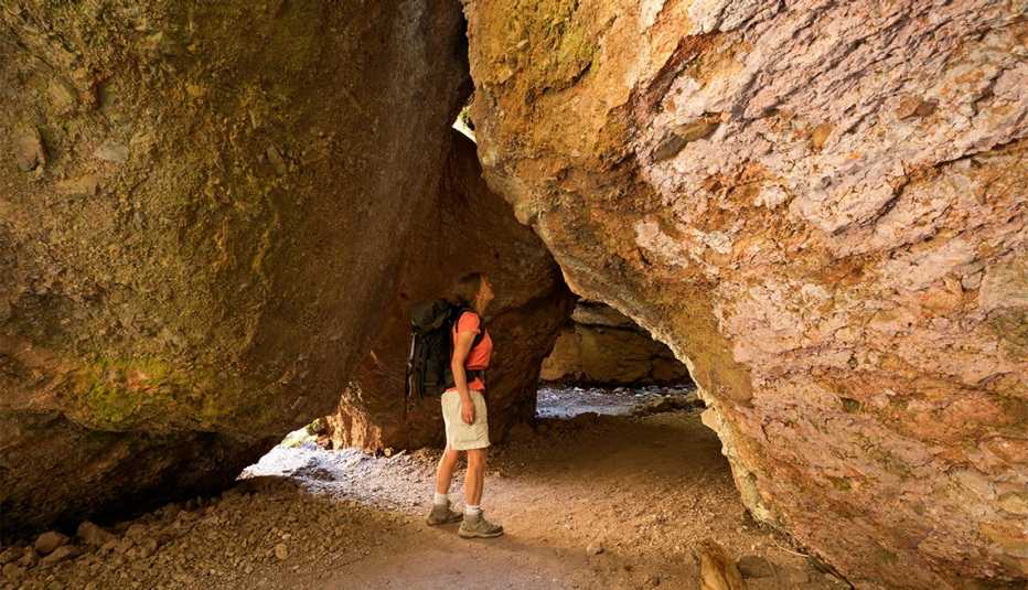 Hiker at the lower entrance to Bear Gulch Cave in Pinnacles National Park