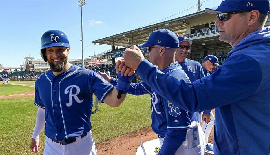 The Kansas City Royals' Alex Gordon is congratulated after scoring during spring training 