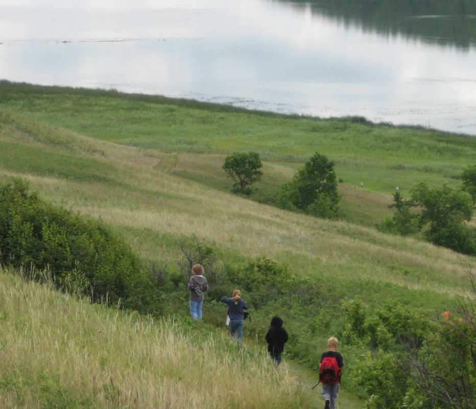 a group of four hikers at Des Lacs National Wildlife Refuge