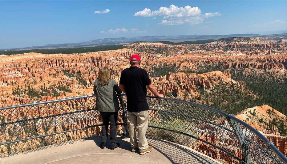 Tourists enjoy the view of the spire-shaped rock formations (hoodoos) in Bryce Canyon National Park, Utah