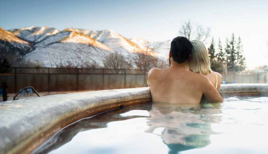 couple soaking in a hot tub in winter