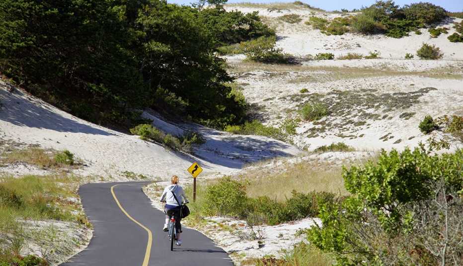 a woman riding bike along the Cape Cod shore