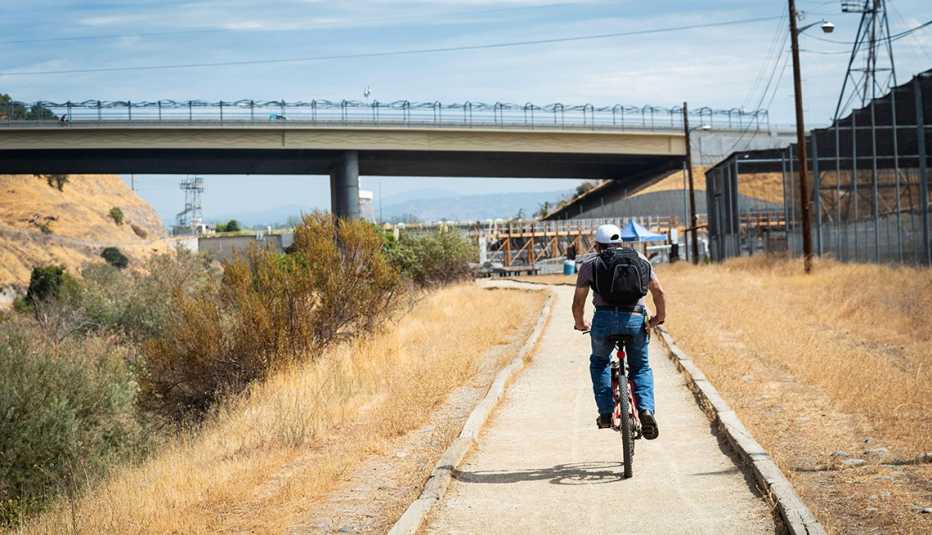 a man bikes along the American River Parkway trail 