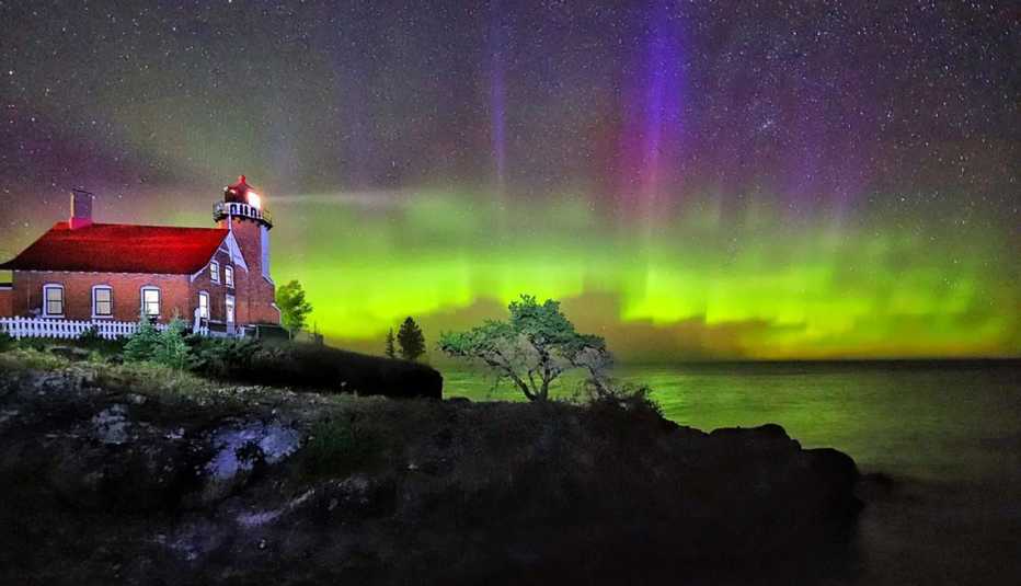 northern lights over a lighthouse in michigan