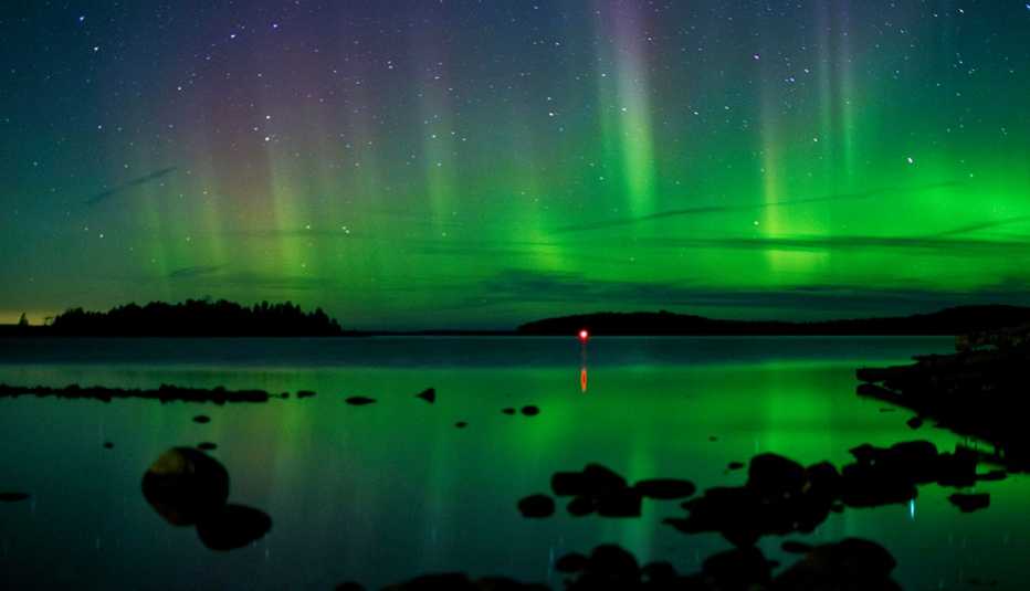 the northern lights over a lake in minnesota