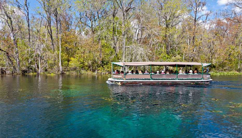 Visitors take boat ride on Silver River at Silver Springs State Park in Ocala, Florida