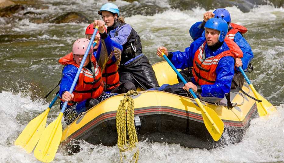 Group of four people with guide whitewater rafting on Arkansas River in Colorado