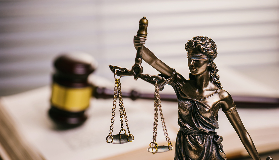 A statue stands in front of a gavel