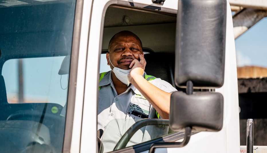 smiling man in the cab of his truck
