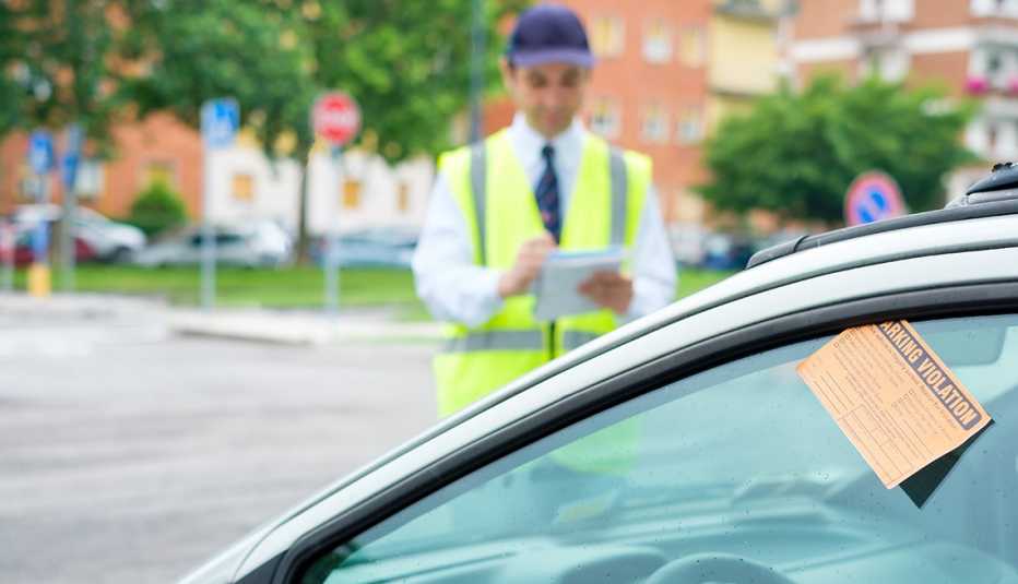 a parking enforcement officer writes a ticket