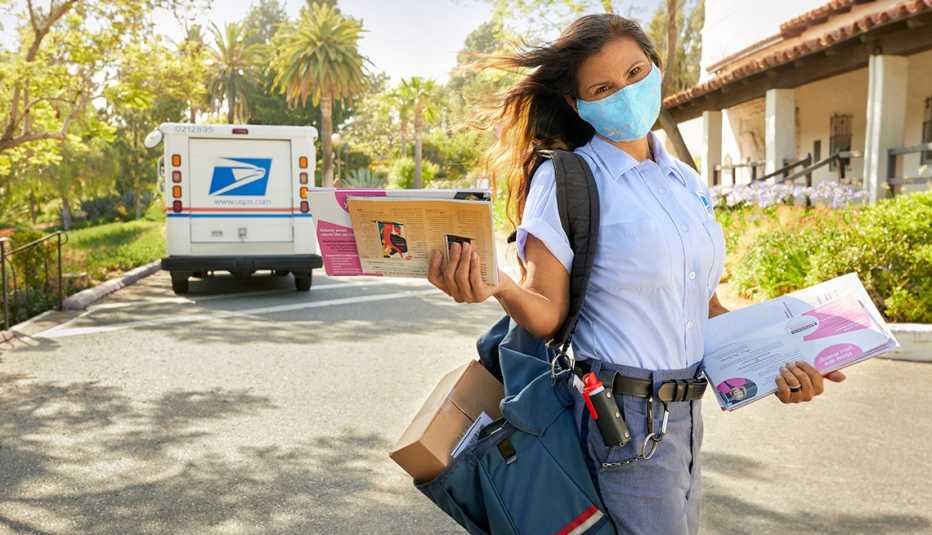 tina weber a mail carrier wearing a mask and delivering mail