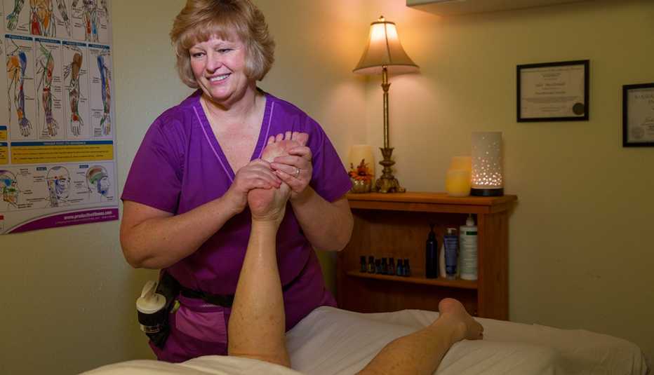 Massage therapist Julie MacDonald massages a client's foot