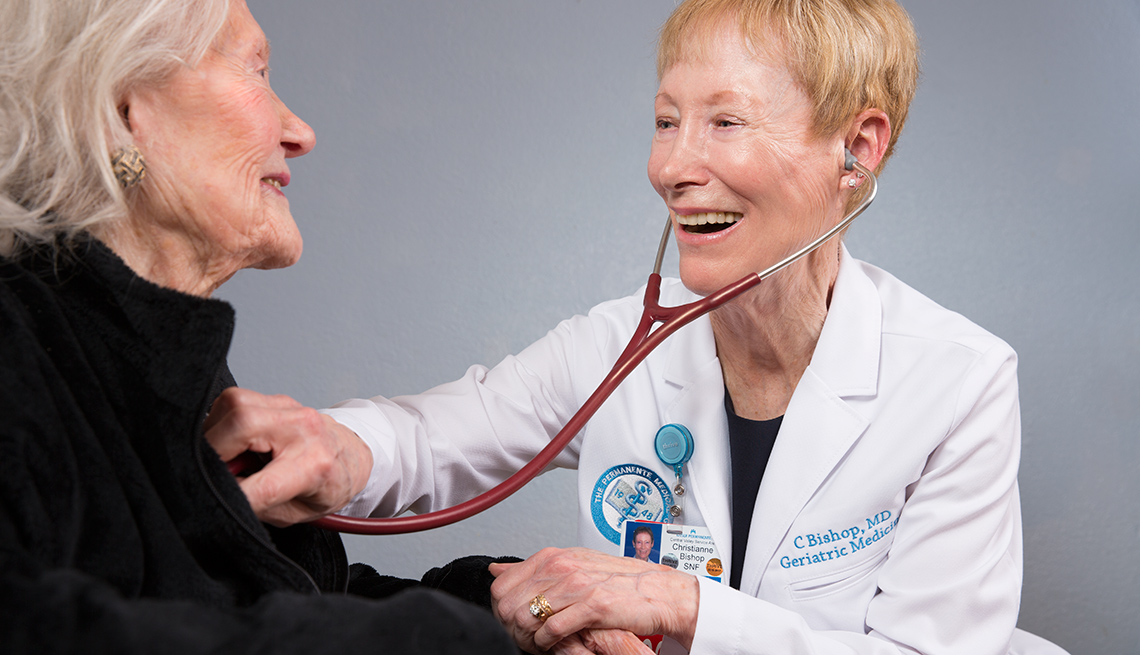 Geriatrician and Physician Christianne Bishop examines a female patient with a stethoscope