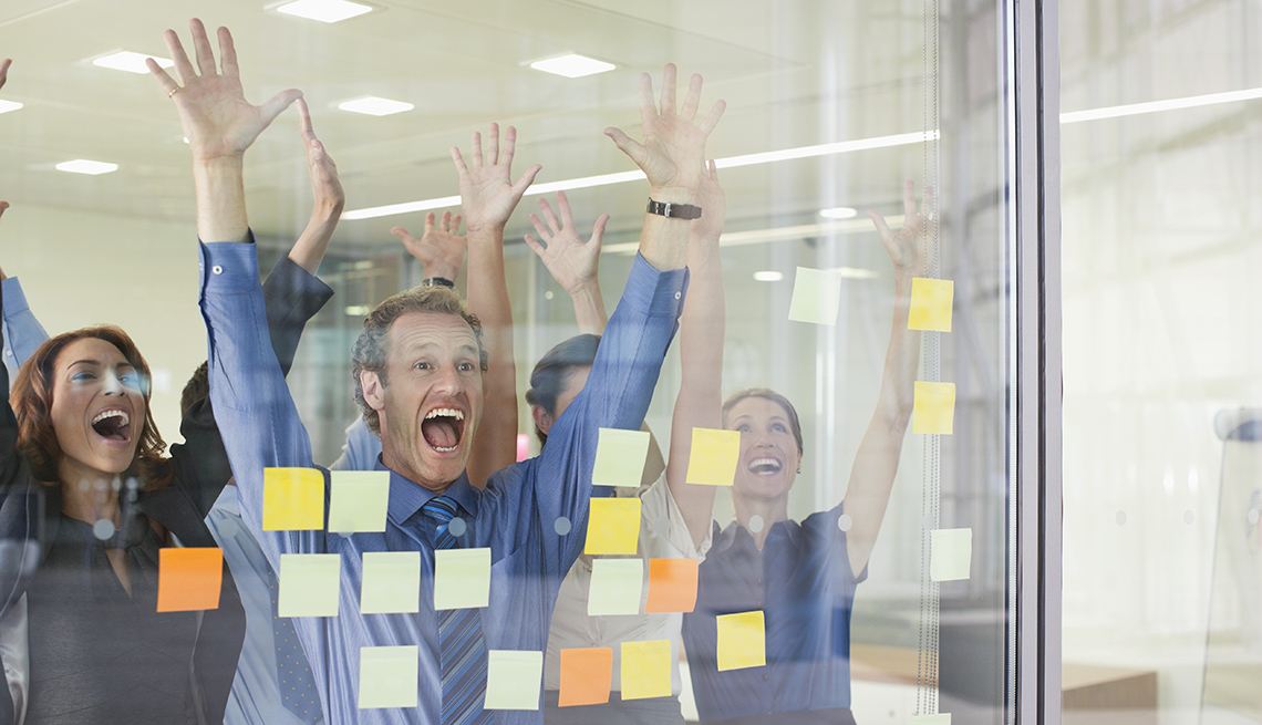 Workers Raise Hands and Shout, Sticky Notes On Glass, Should You Ever Volunteer For a Layoff?