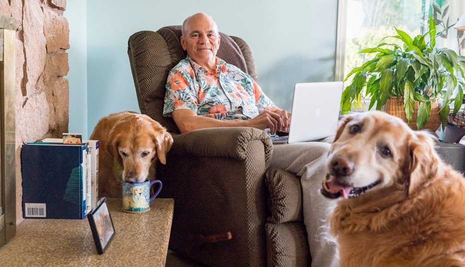 Jim Ratzlaff working at home with this two dogs.