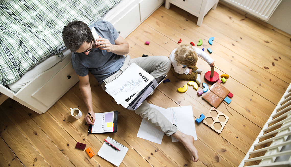 A man is working from home with a child