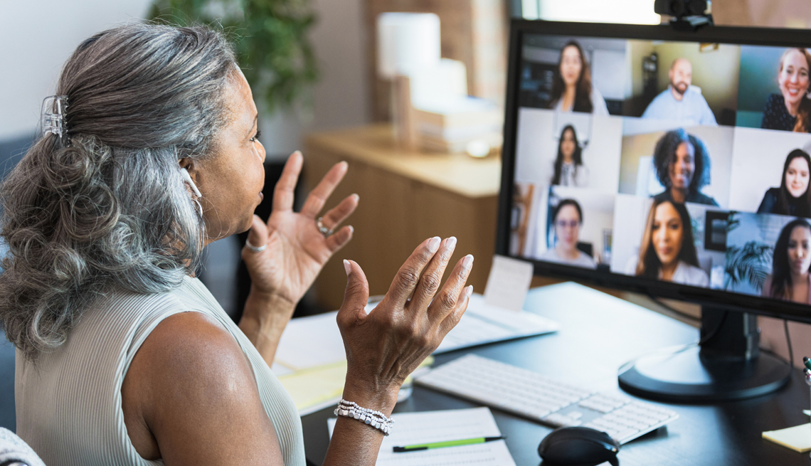 a woman working from home video conferencing her colleagues