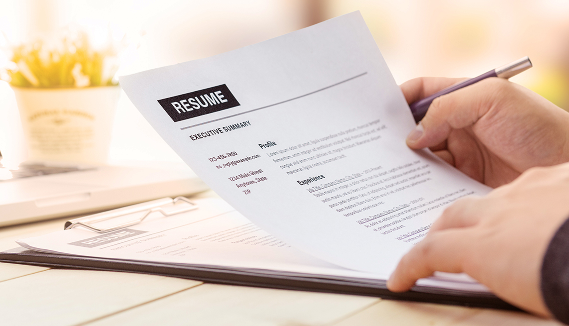 hands holding a resume 