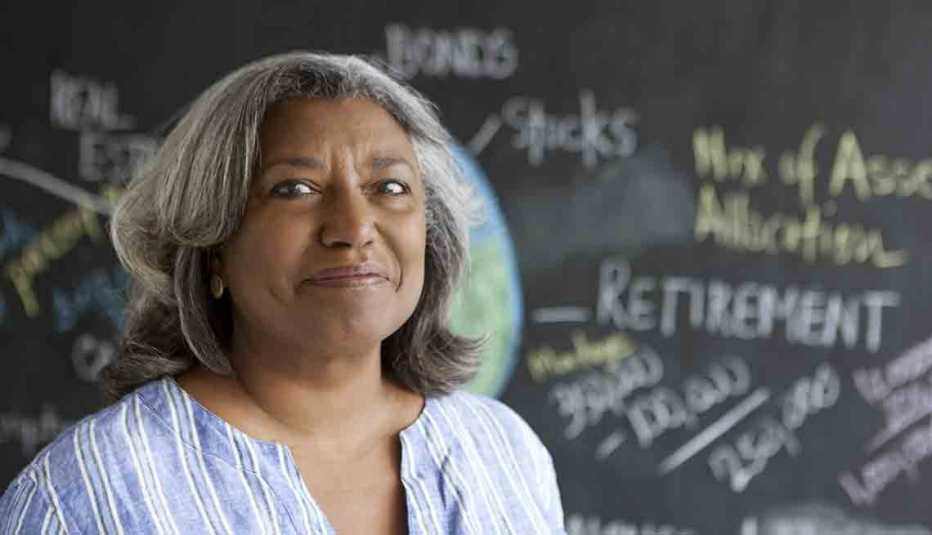 Senior Woman Smiling In Front Of Blackboard That Reads 'Retirement', Jenkins ‘Saving for Your Future’