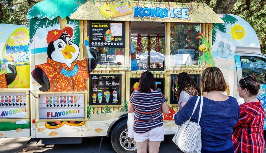 People waiting in line at a kona ice truck