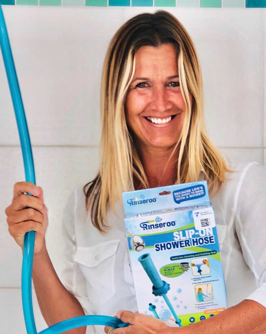 entrepreneur lisa lane poses with her slip on shower hose product