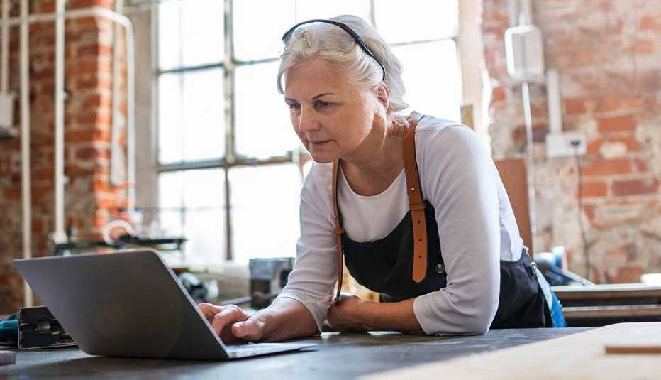 A woman is working on her laptop at her small business