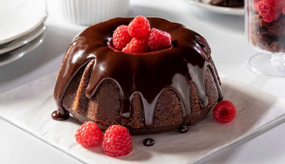 Beautiful mini chocolate bundt cake with chocolate ganache and raspberries