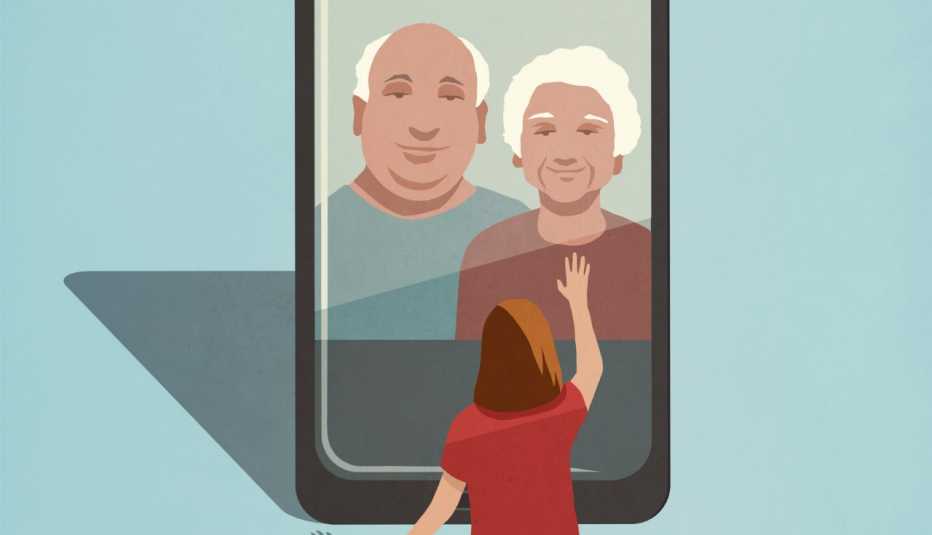 Un niño pequeño saluda a sus abuelos que aparecen en la pantalla de un teléfono inteligente de tamaño natural.