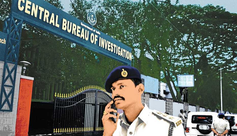 Policía en la India habla por teléfono frente a la oficina del Buró Central de Investigación (CBI), Bangalore, 2018