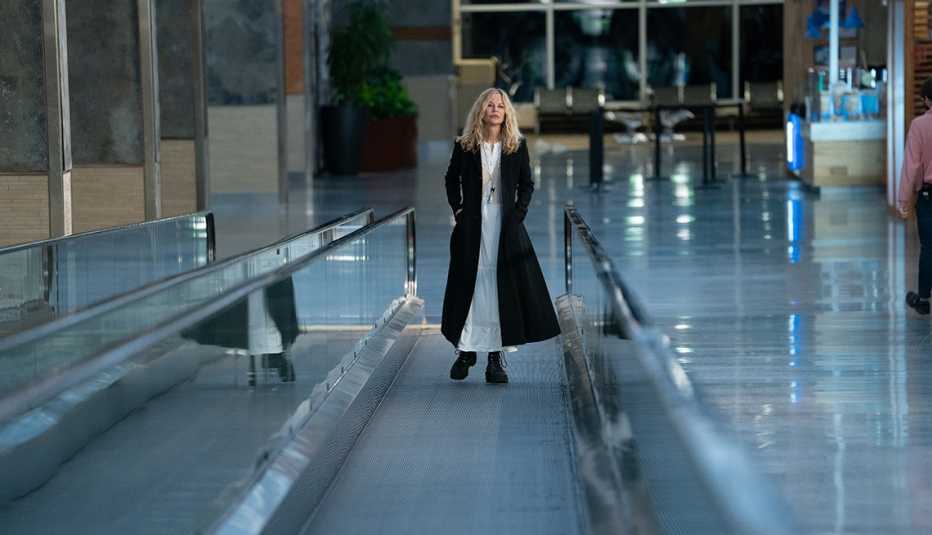 Meg Ryan walking on a moving walkway at an airport in the film "What Happens Later."