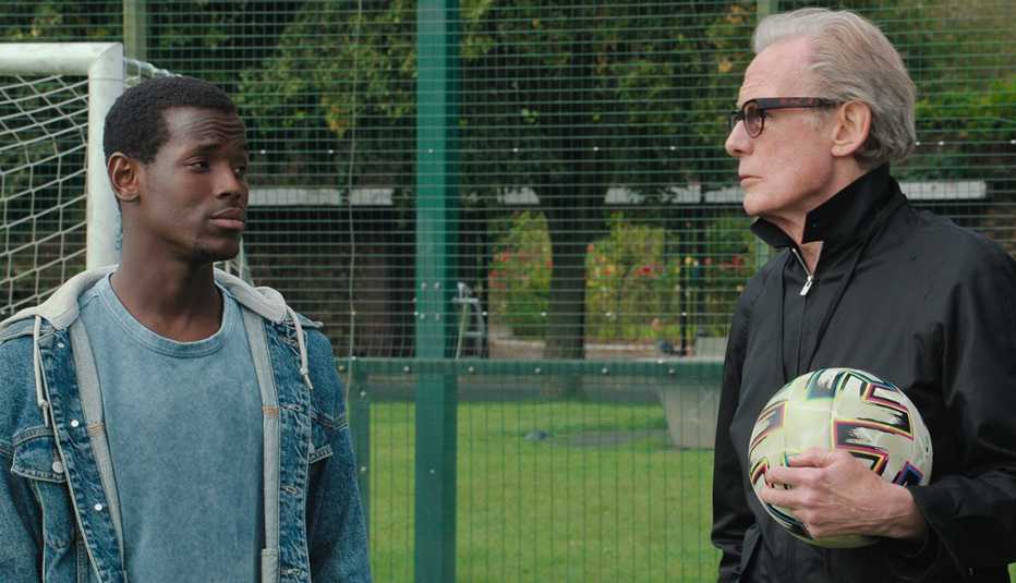 Micheal Ward and Bill Nighy looking at each other in a scene from "The Beautiful Game."