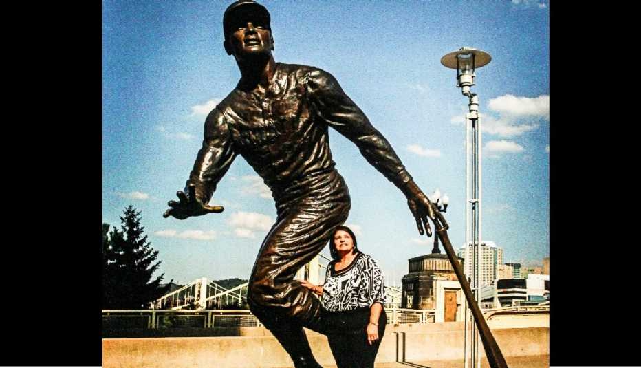 Vera Clemente junto a la estatua de bronce de su esposo Roberto Clemente en el estadio PNC Park en Pittsburgh.