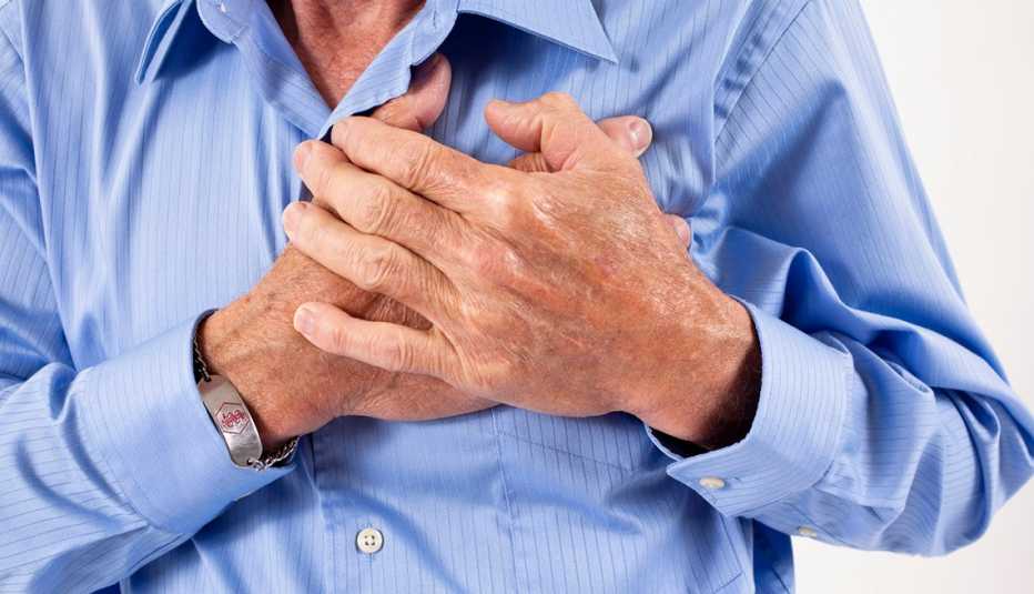 Middle Aged Man Clutches Chest, Can Sex Lead To A Heart Attack?