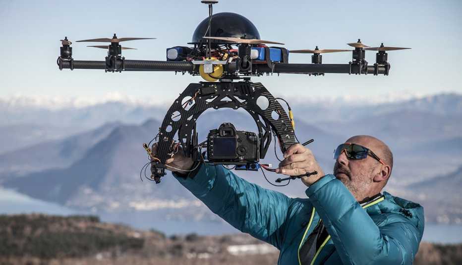 Man Prepares To Release Drone Into Sky, AARP Technology, Innovations, Things You Should Know Before Buying A Drone