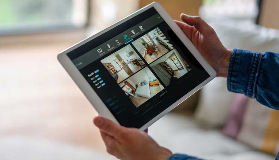 Persona monitorea las cámaras de su casa en una tableta