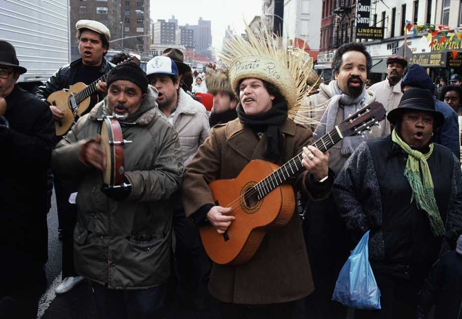 Personas con instrumentos cantando en la calle
