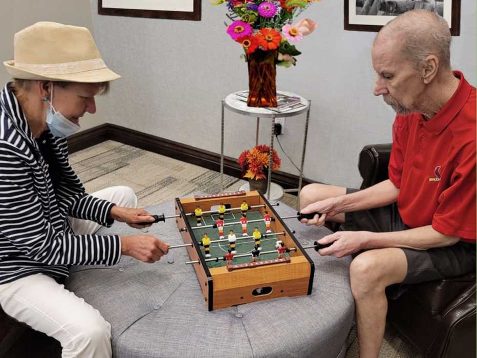 marianne boyce parker plays a small tabletop football game with her brother john boyce