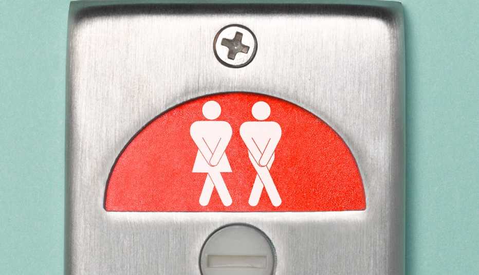 Letrero de un baño donde ambas siluetas, de una mujer y un hombre, cruzan sus piernas aguantando su deseo de orinar