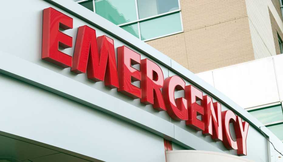 Rótulo color rojo que dice emergencia a la entrada de una sala de emergencias de un hospital