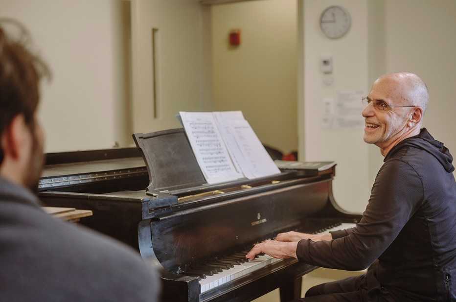 Jeffrey Galvin sonríe mientras toma clases de piano. Su profesor, Jason Solounias, lo observa