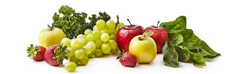 Uvas, fresas, manzanas verdes y rojas y vegetales de hoja verde