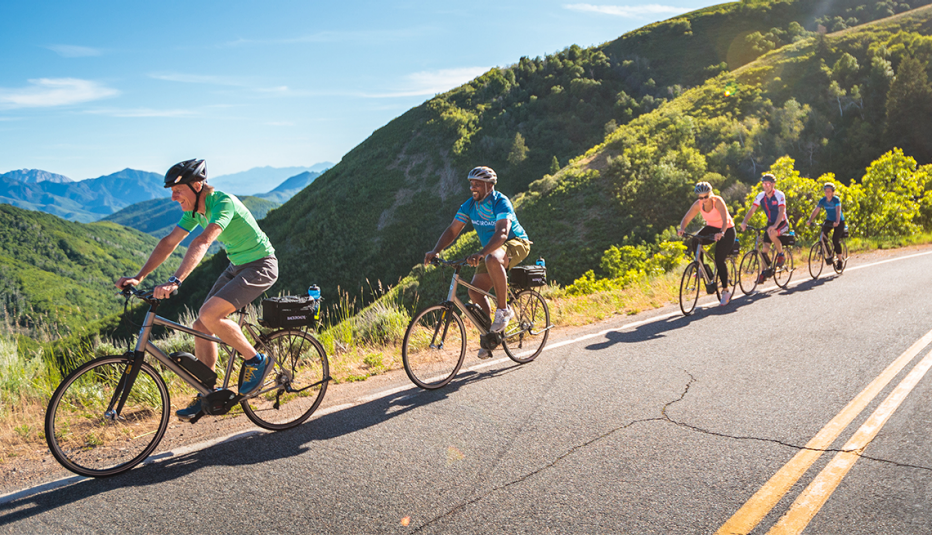 personas montan bicicletas eléctricas en una ruta para principiantes a través de las montañas