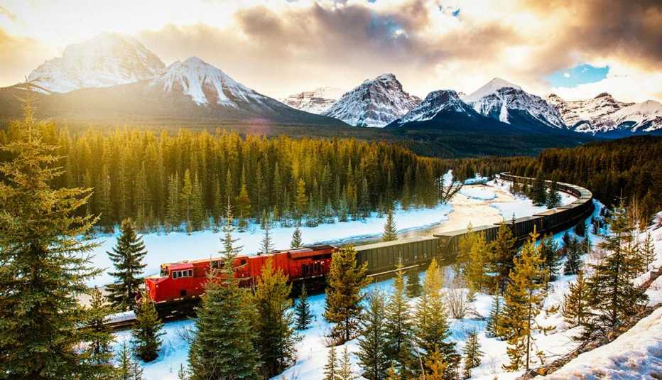 Tren recorriendo en medio de montañas nevadas