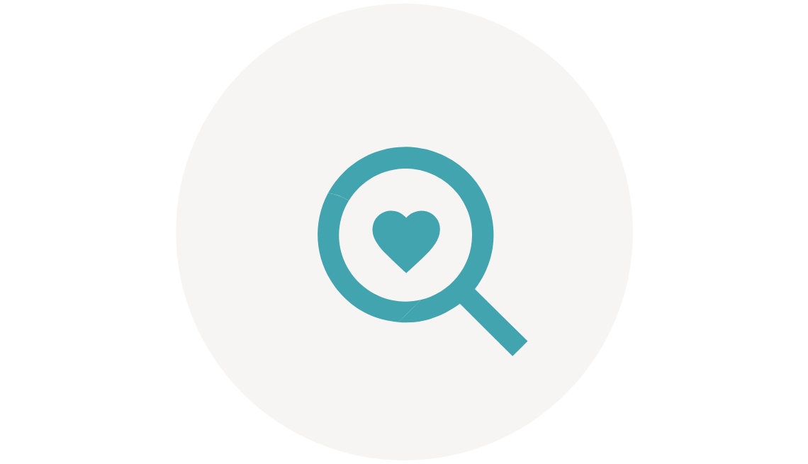 Caregiving Community Resource Finder Icon. A heart inside a magnifying glass