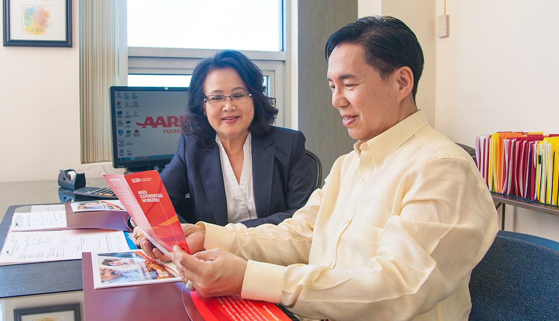 Asian man and woman, meeting in AARP office, AARP Foundation, Senior Community Service Employment Program