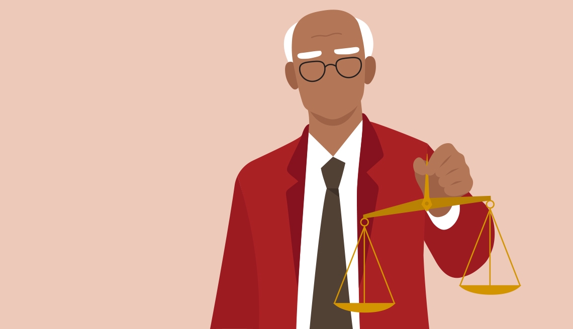 Elderly man dressed in a suit holding justice scale