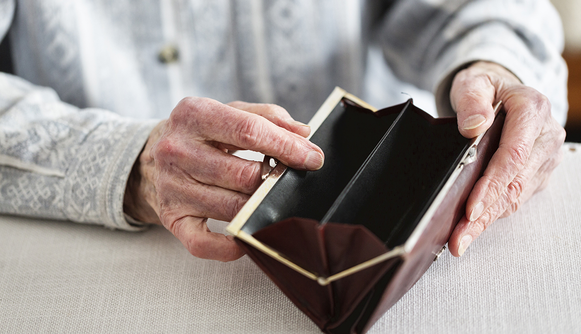 Hands of senior woman, 90 years old, holding empty purse